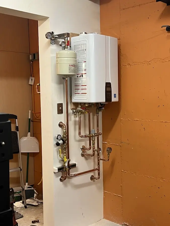 Plumbing technician inspecting water heater connections in Oregon City